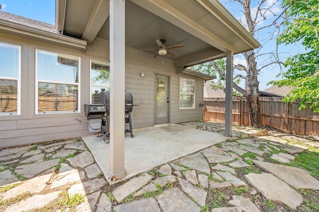 view of patio with a grill, fence, and a ceiling fan