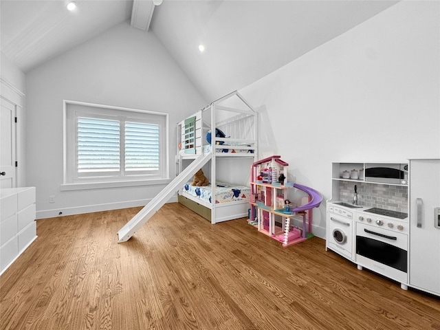 rec room featuring vaulted ceiling with beams, baseboards, and wood finished floors