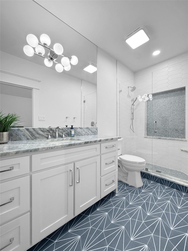 full bath with vanity, tile patterned flooring, a stall shower, and toilet