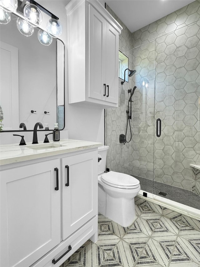 full bath with vanity, tile patterned flooring, toilet, and a shower stall