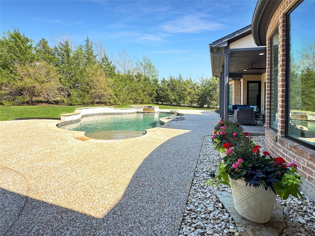 pool with a ceiling fan and a patio area