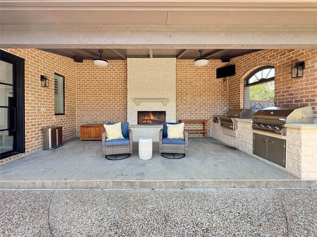 view of patio / terrace featuring area for grilling and a fireplace