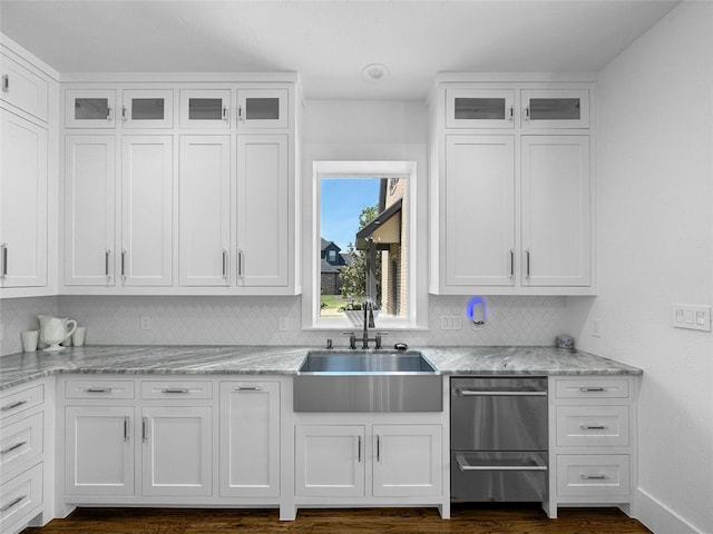 kitchen featuring a sink, white cabinetry, and tasteful backsplash