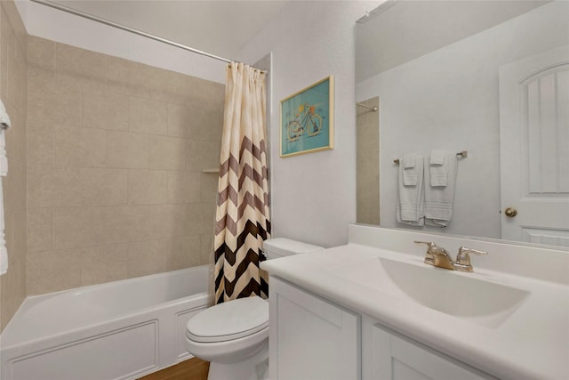 bathroom with toilet, shower / bath combo with shower curtain, and vanity