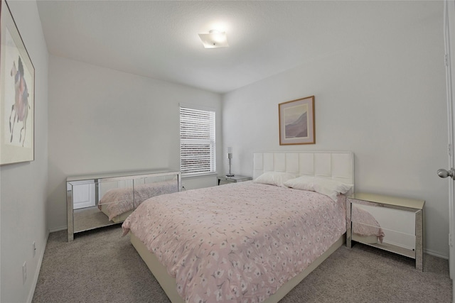 bedroom with carpet flooring and baseboards