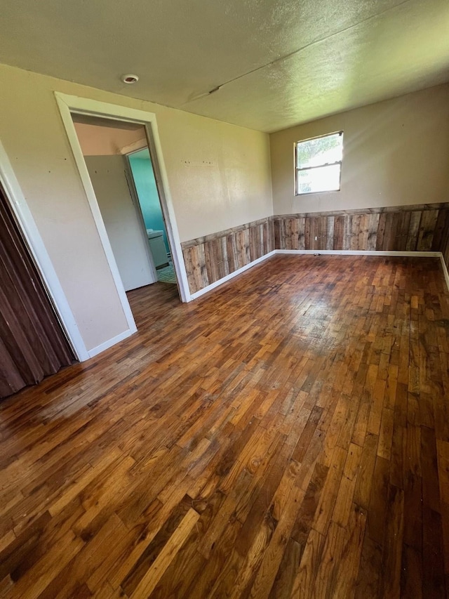 305 County Road 1607, Clifton, TX 76634 - unfurnished room featuring wood-type flooring and wainscoting