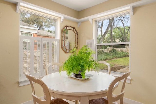 dining space with a healthy amount of sunlight and baseboards