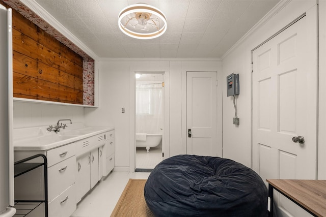 interior space with vanity, ornamental molding, and a soaking tub