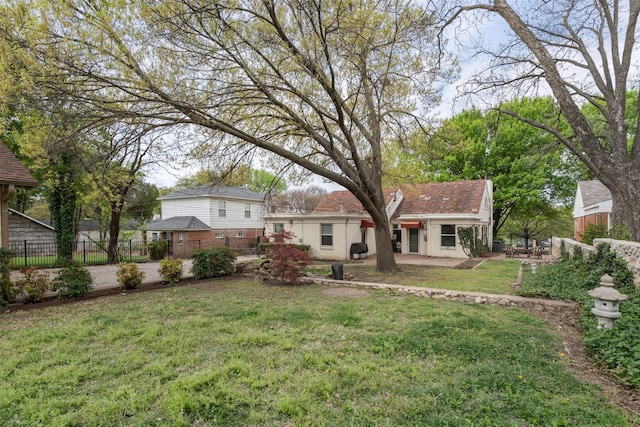 back of property featuring a patio area, fence, and a yard