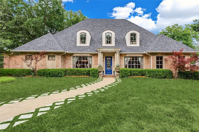 11484 Strait Ln, Dallas, TX 75229 - french country inspired facade with brick siding, roof with shingles, and a front yard