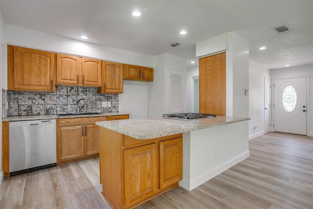 436 Nathan St, Burleson, TX 76028 - kitchen featuring appliances with stainless steel finishes, a sink, light wood-style flooring, decorative backsplash, and recessed lighting