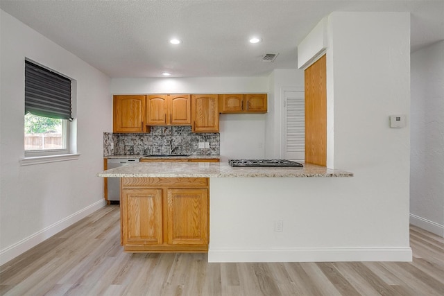 436 Nathan St, Burleson, TX 76028 - kitchen with stainless steel dishwasher, light stone counters, a sink, light wood-style flooring, and black gas cooktop
