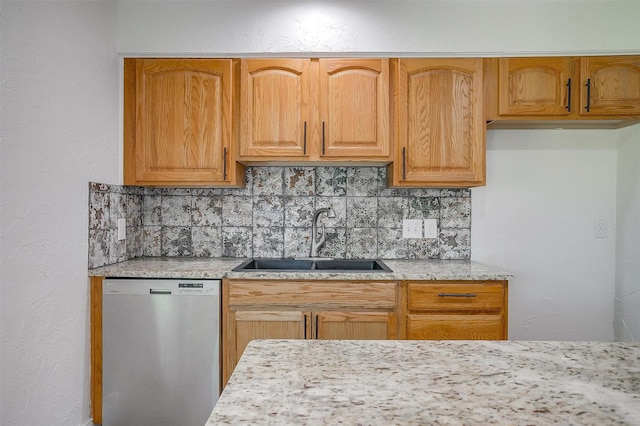 436 Nathan St, Burleson, TX 76028 - kitchen with stainless steel dishwasher, a sink, decorative backsplash, light stone counters, and a textured wall