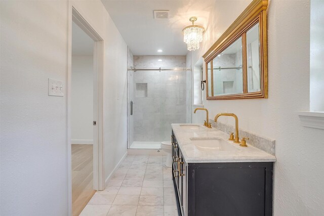 436 Nathan St, Burleson, TX 76028 - full bath featuring a chandelier, double vanity, a shower stall, marble look tiles, and toilet