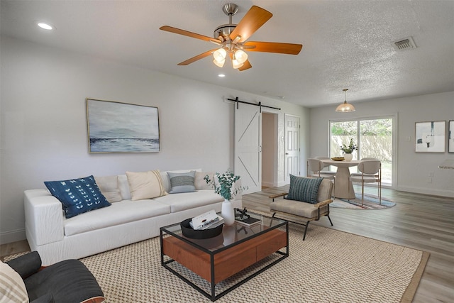 436 Nathan St, Burleson, TX 76028 - living area featuring a barn door, wood finished floors, baseboards, recessed lighting, and a ceiling fan