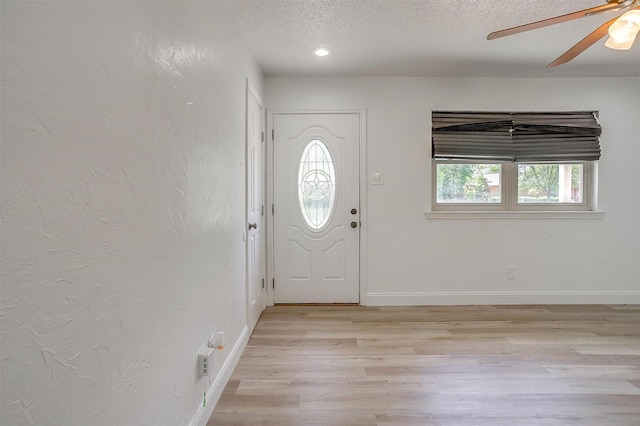 436 Nathan St, Burleson, TX 76028 - entrance foyer with a textured ceiling, light wood-style floors, baseboards, and ceiling fan