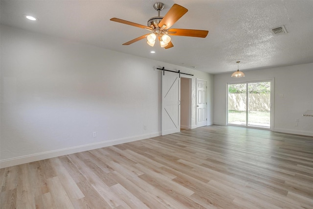 436 Nathan St, Burleson, TX 76028 - spare room featuring a barn door, light wood finished floors, baseboards, recessed lighting, and a ceiling fan