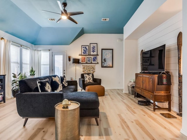 living area featuring visible vents, a ceiling fan, and wood finished floors