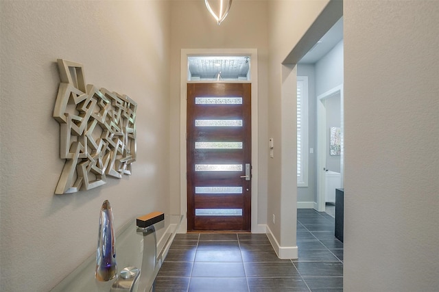 entryway featuring dark tile patterned flooring