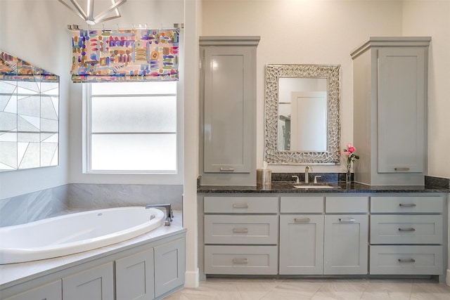 full bath featuring vanity and a bath