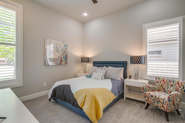 bedroom with a ceiling fan, baseboards, multiple windows, and recessed lighting