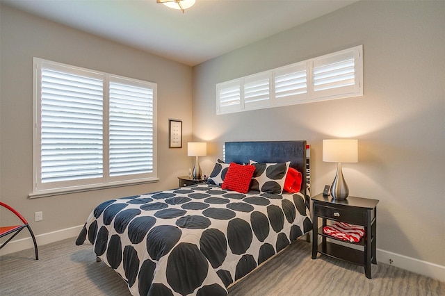 carpeted bedroom with multiple windows and baseboards