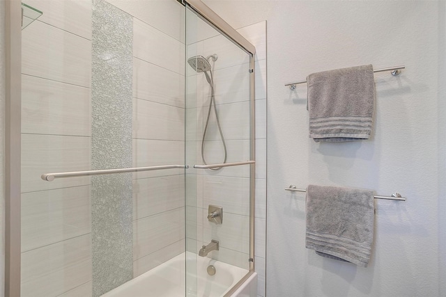 full bathroom featuring combined bath / shower with glass door