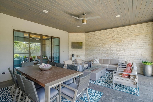 view of patio featuring outdoor dining area, a ceiling fan, and an outdoor living space with a fire pit