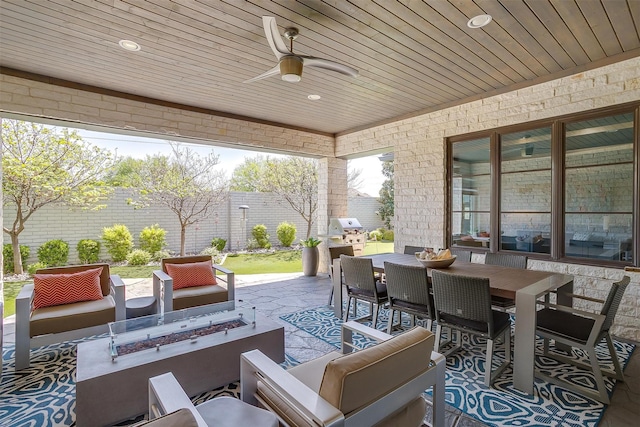 view of patio with an outdoor living space with a fire pit, a ceiling fan, and outdoor dining area