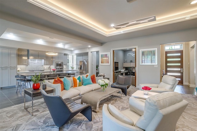living room with a tray ceiling and recessed lighting