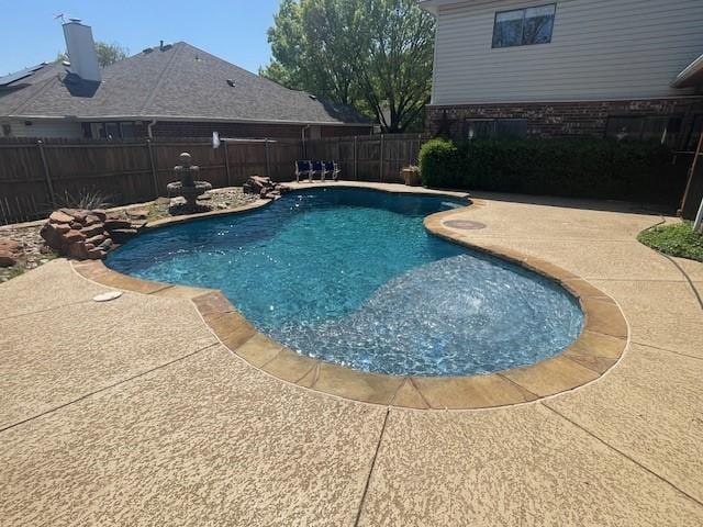 view of pool featuring a patio and a fenced backyard
