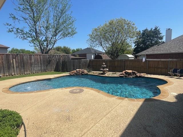 view of swimming pool featuring a fenced in pool, a patio, and a fenced backyard