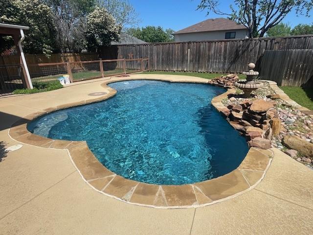 view of pool with a fenced backyard, a fenced in pool, and a patio