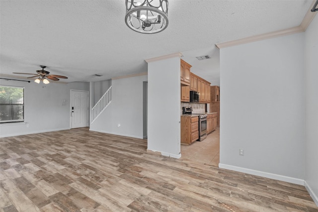unfurnished living room featuring light wood-style flooring, visible vents, and a textured ceiling