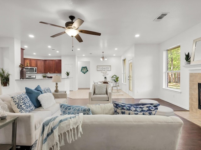 living area with recessed lighting, a fireplace, visible vents, and ceiling fan