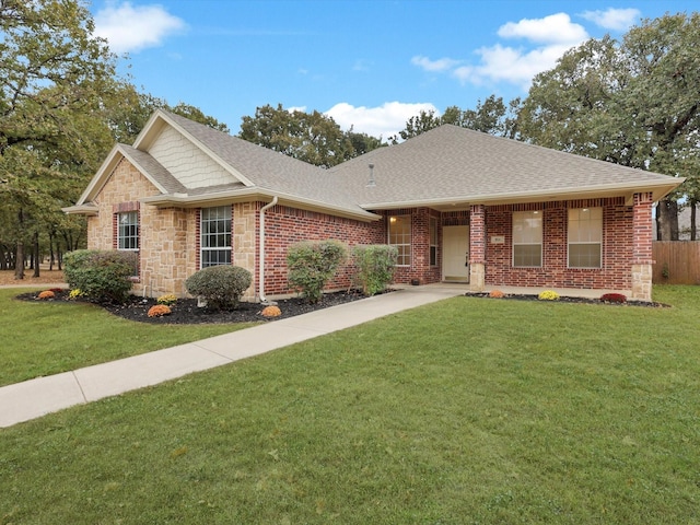 single story home with brick siding, a front lawn, and roof with shingles