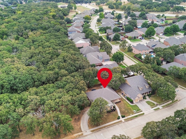 bird's eye view featuring a wooded view and a residential view