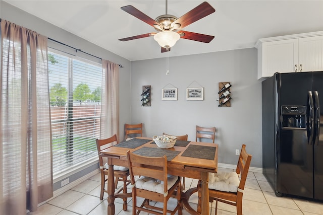 dining area featuring a ceiling fan, light tile patterned flooring, and a healthy amount of sunlight