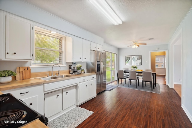 1120 S Valentine Dr, Sherman, TX 75090 - kitchen with stainless steel fridge, a sink, light countertops, white cabinetry, and a textured ceiling
