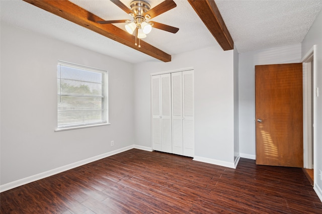 1120 S Valentine Dr, Sherman, TX 75090 - unfurnished bedroom with beam ceiling, a closet, dark wood-type flooring, baseboards, and ceiling fan