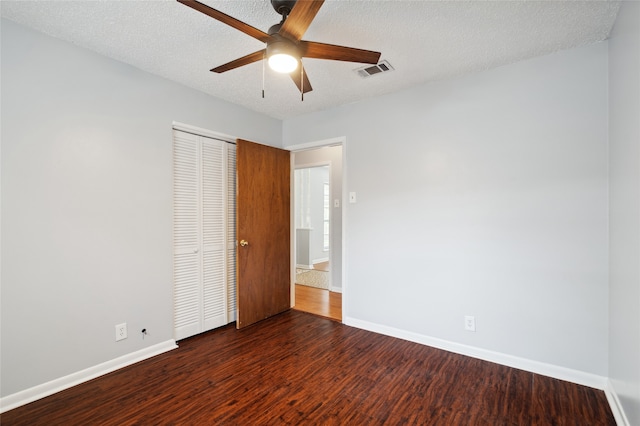 1120 S Valentine Dr, Sherman, TX 75090 - unfurnished bedroom featuring baseboards, wood finished floors, a closet, a textured ceiling, and ceiling fan