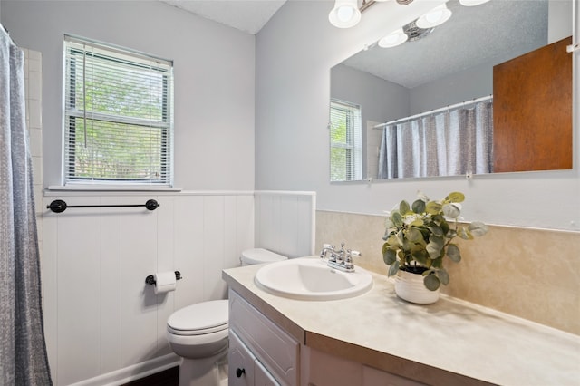 1120 S Valentine Dr, Sherman, TX 75090 - bathroom with vanity, toilet, a wainscoted wall, and a shower with curtain