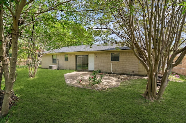 1120 S Valentine Dr, Sherman, TX 75090 - back of property with brick siding, a patio area, a yard, and cooling unit