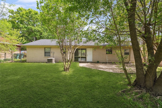 1120 S Valentine Dr, Sherman, TX 75090 - rear view of house with brick siding and a patio area
