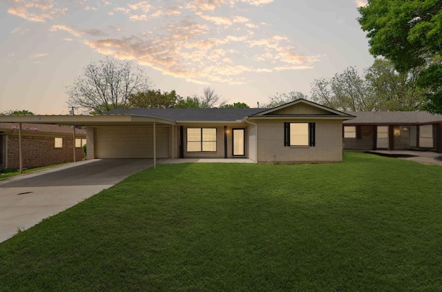 1120 S Valentine Dr, Sherman, TX 75090 - ranch-style home featuring an attached garage, brick siding, concrete driveway, and a lawn