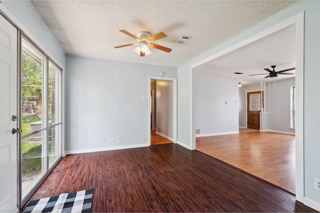 1120 S Valentine Dr, Sherman, TX 75090 - empty room featuring ceiling fan, a textured ceiling, wood finished floors, and baseboards