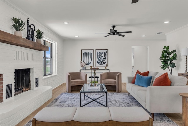 living room with recessed lighting, wood finished floors, ornamental molding, and ceiling fan