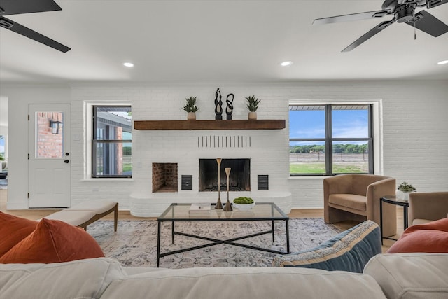 living room featuring recessed lighting, visible vents, a ceiling fan, and wood finished floors
