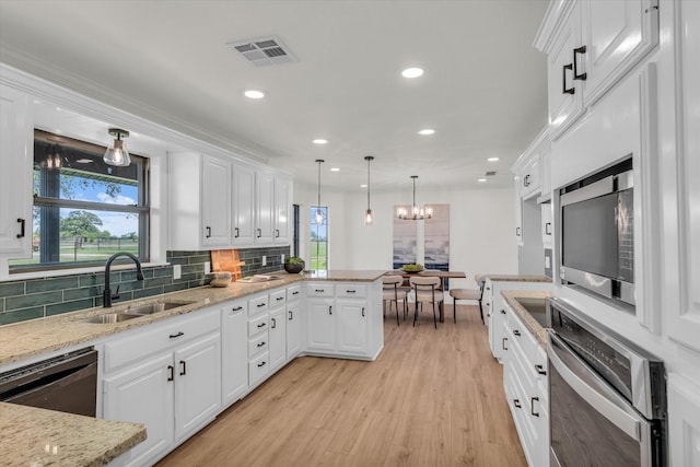 kitchen featuring a sink, visible vents, white cabinets, and appliances with stainless steel finishes