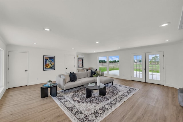 living room featuring recessed lighting, light wood finished floors, and baseboards